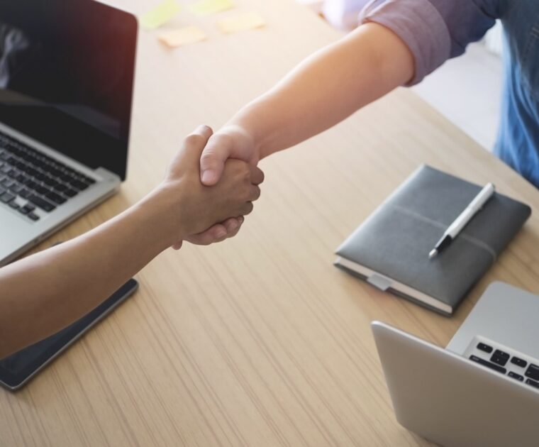 Close up of a handshake between a client and a service provider